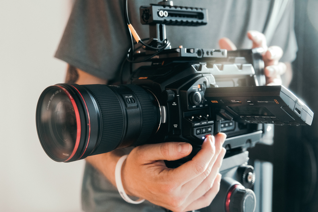 Photo of a Person Holding a Black Camera